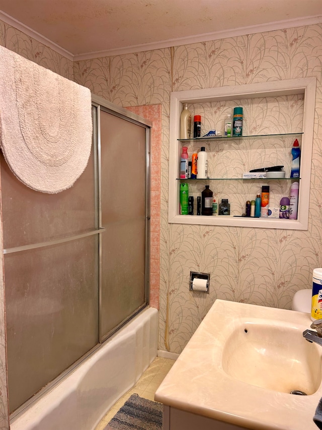 full bathroom featuring bath / shower combo with glass door, toilet, vanity, crown molding, and tile patterned floors