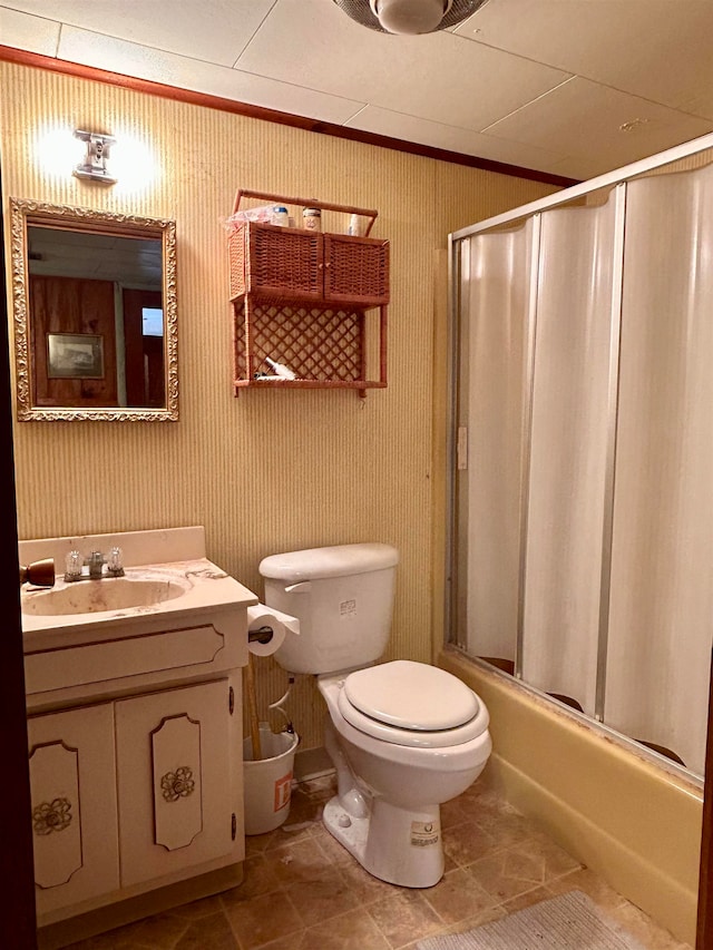 full bathroom featuring vanity, bath / shower combo with glass door, toilet, and tile patterned floors