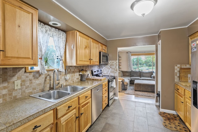 kitchen with light tile patterned floors, stainless steel appliances, tasteful backsplash, and sink