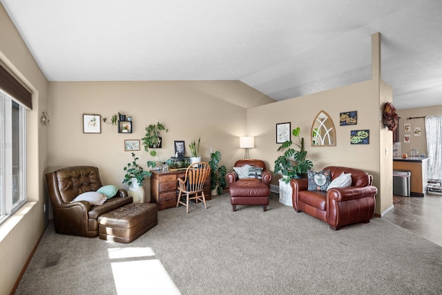 carpeted living room featuring lofted ceiling and plenty of natural light