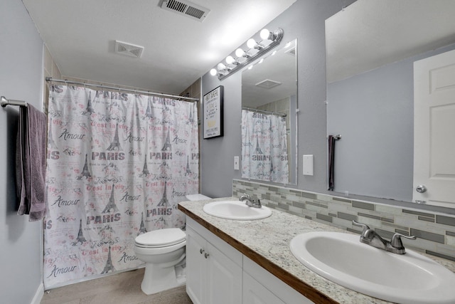 bathroom with backsplash, toilet, vanity, a shower with curtain, and tile patterned flooring