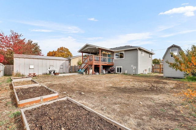 back of house featuring a storage shed and a deck