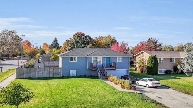 view of front of home with a front lawn and a garage