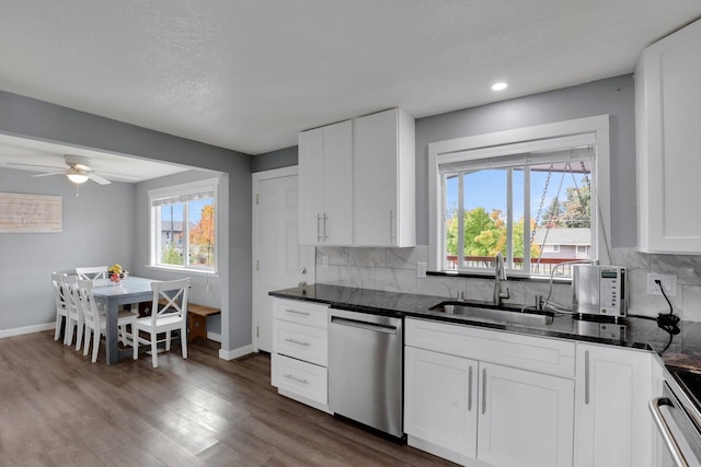 kitchen with a wealth of natural light, sink, appliances with stainless steel finishes, and white cabinetry