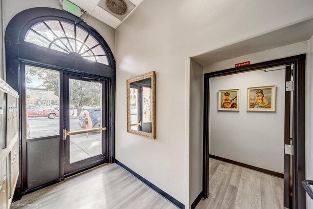 entryway with french doors and light hardwood / wood-style floors