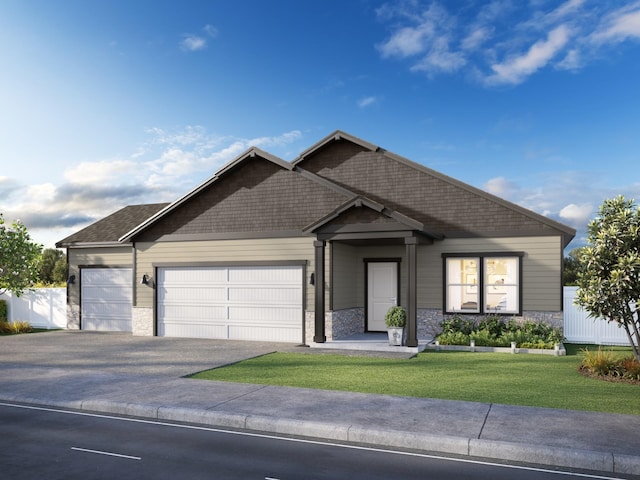 craftsman house featuring a front lawn and a garage