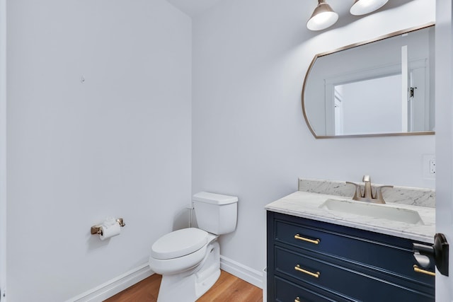 bathroom featuring vanity, toilet, and wood-type flooring