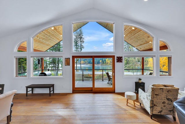 interior space with high vaulted ceiling, light wood-type flooring, and wooden ceiling