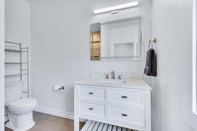 bathroom featuring vanity, toilet, and tile patterned flooring