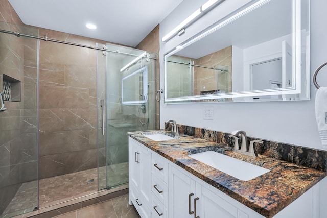 bathroom featuring vanity, an enclosed shower, and tile patterned flooring