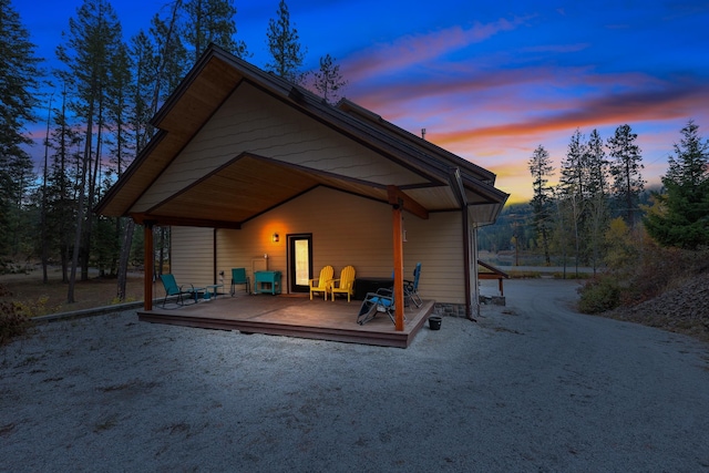 back house at dusk with a deck