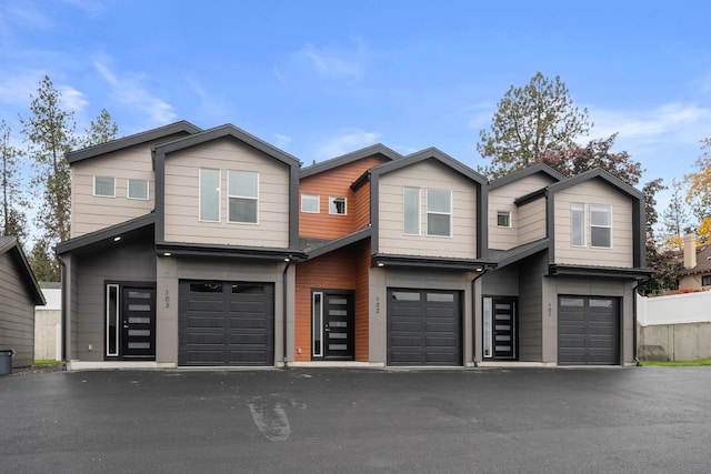 view of front facade with aphalt driveway and a garage
