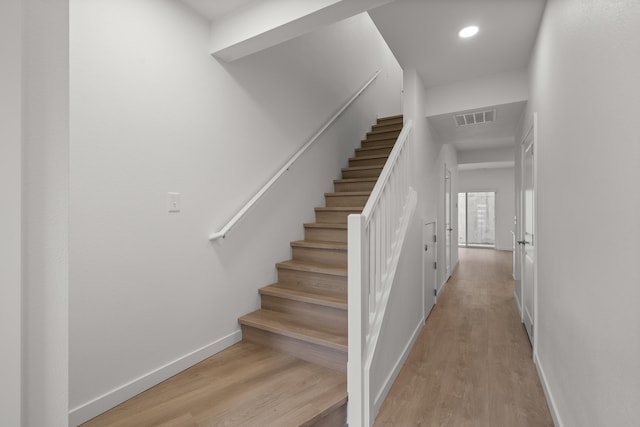 stairway with visible vents, recessed lighting, baseboards, and wood finished floors