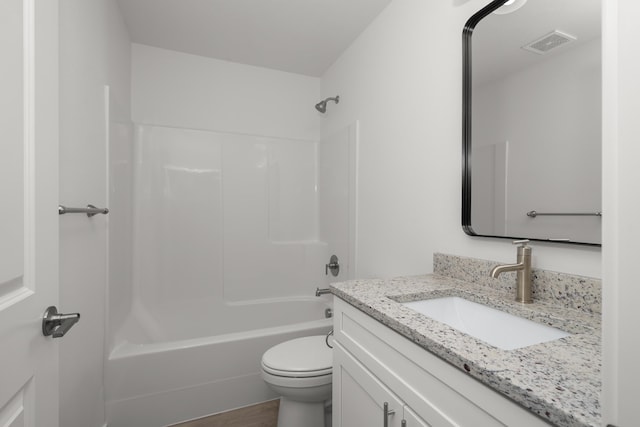 full bathroom with bathtub / shower combination, vanity, hardwood / wood-style flooring, and toilet