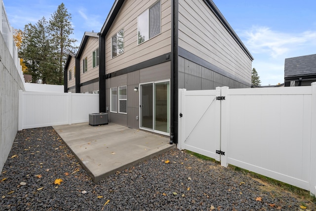 back of house with central air condition unit, a patio, a gate, and a fenced backyard