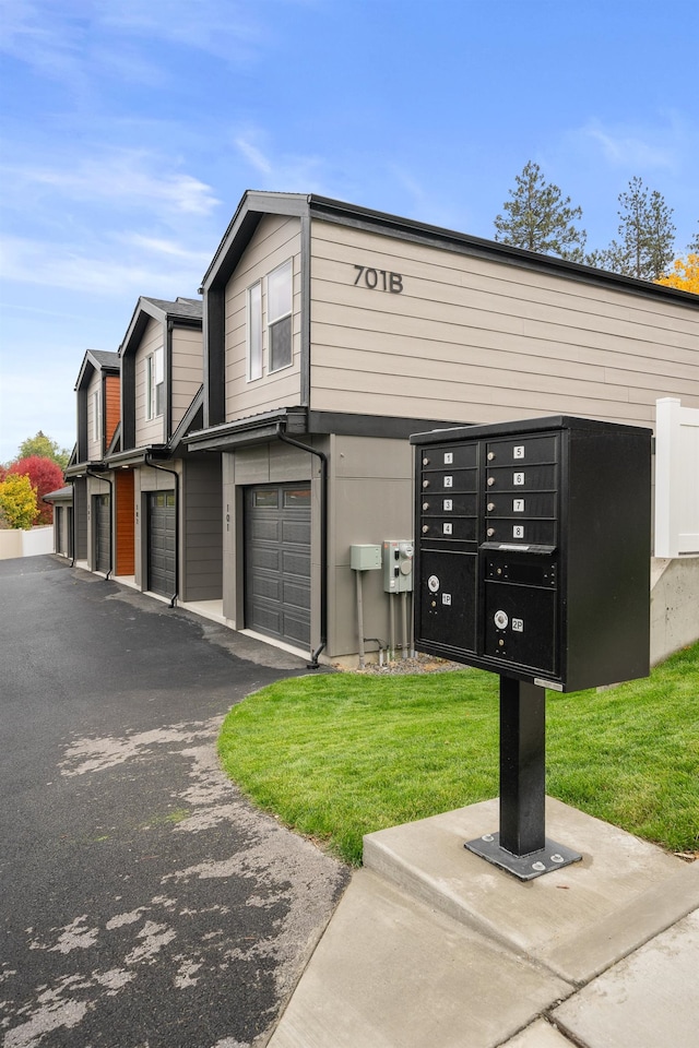 view of property's community with a yard and mail boxes