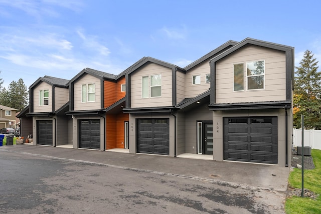 view of front of home featuring central AC and a garage