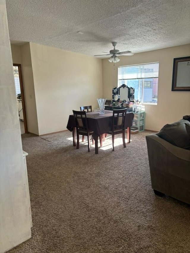 dining area featuring carpet flooring, a textured ceiling, and ceiling fan