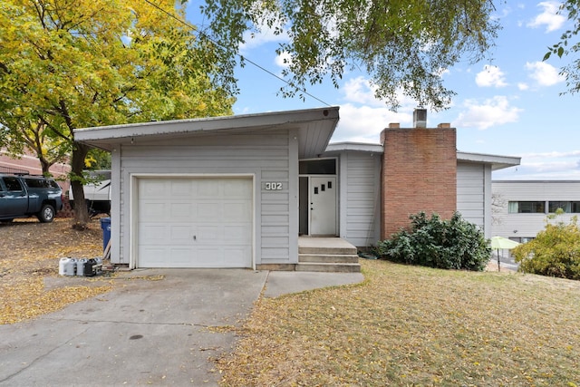 ranch-style home featuring a garage and a front yard