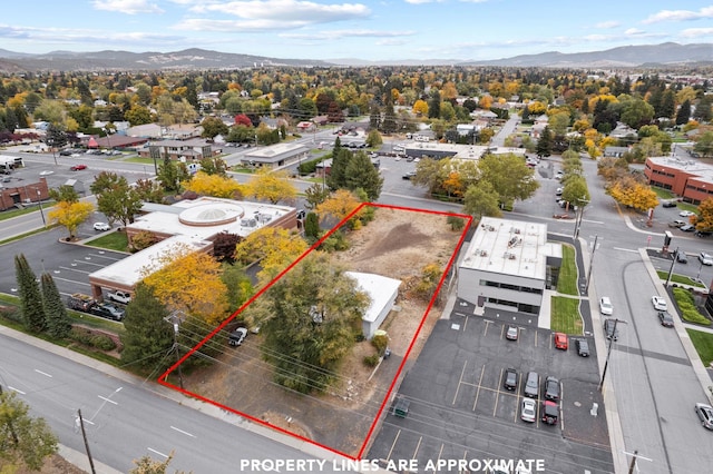 302 N Argonne Rd, Spokane Valley, WA 99212 - aerial overview of property's location with property boundaries highlighted and a mountain backdrop