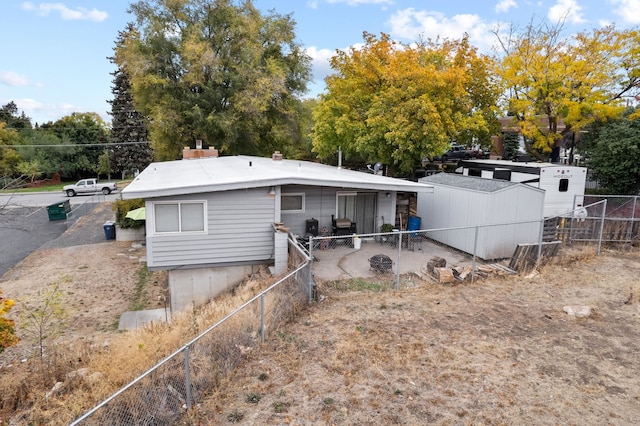 302 N Argonne Rd, Spokane Valley, WA 99212 - rear view of property featuring fence, a patio area, and view of wooded area