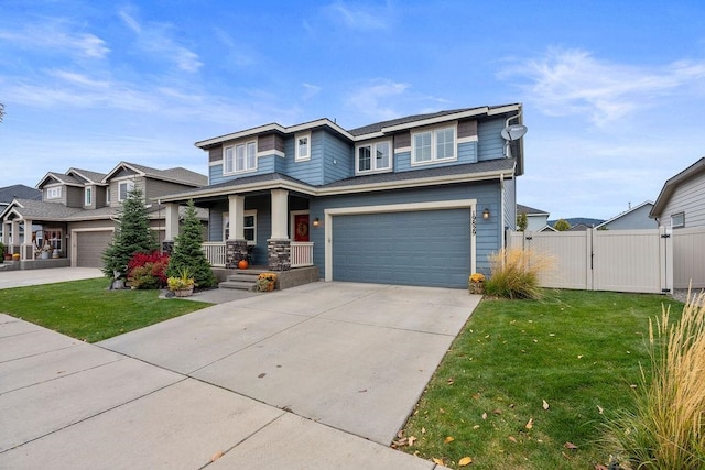 view of front of house with covered porch, a front yard, and a garage