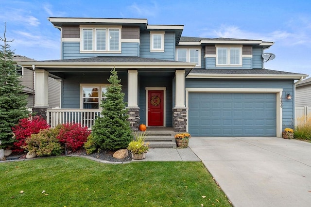 view of front facade featuring a porch, a front yard, and a garage