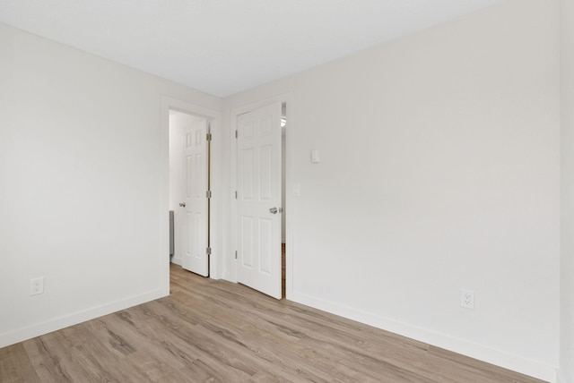 spare room with light hardwood / wood-style flooring