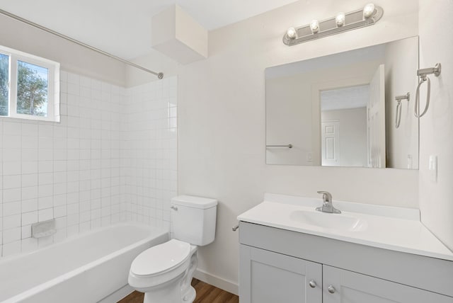 full bathroom with vanity, toilet, hardwood / wood-style flooring, and tiled shower / bath combo