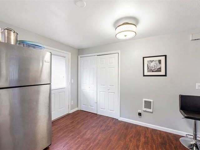 unfurnished office featuring dark hardwood / wood-style flooring