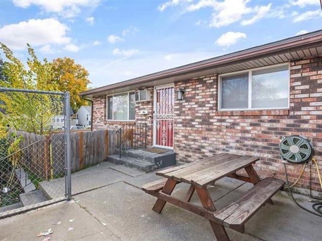 711 E Broad Avenue 715E Broad Ave, Spokane, WA 99207 - view of front of house with fence, outdoor dining area, brick siding, and a patio