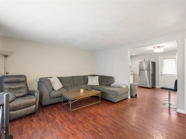 711 E Broad Avenue 715E Broad Ave, Spokane, WA 99207 - living room featuring baseboards and wood finished floors