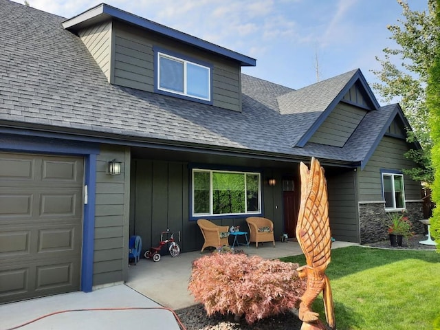 view of front of house with a garage and a front lawn