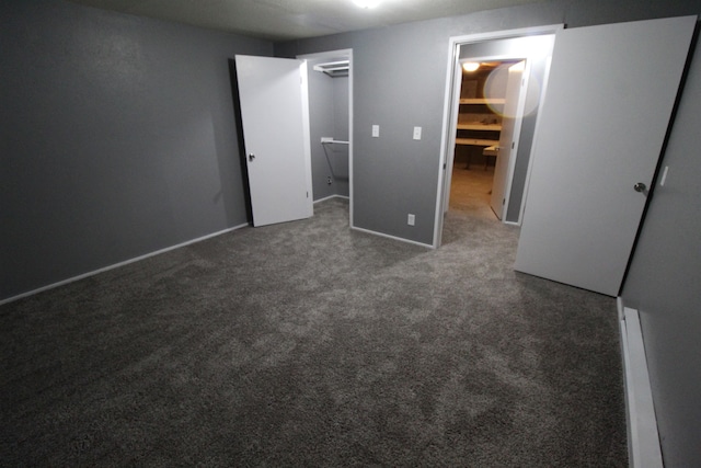 unfurnished bedroom with dark colored carpet