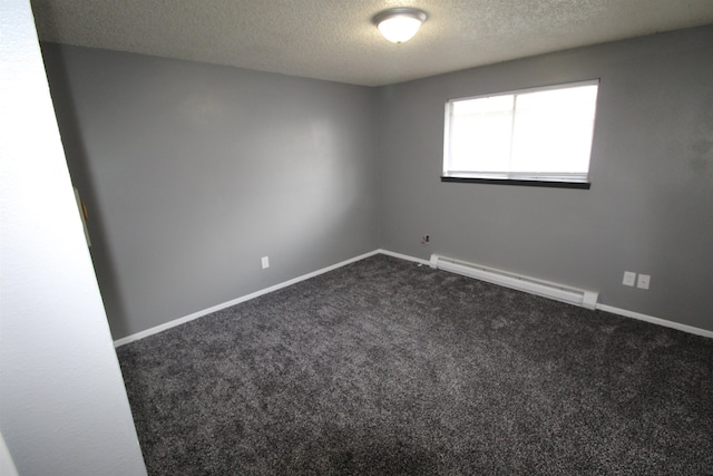 empty room with baseboard heating, dark colored carpet, and a textured ceiling