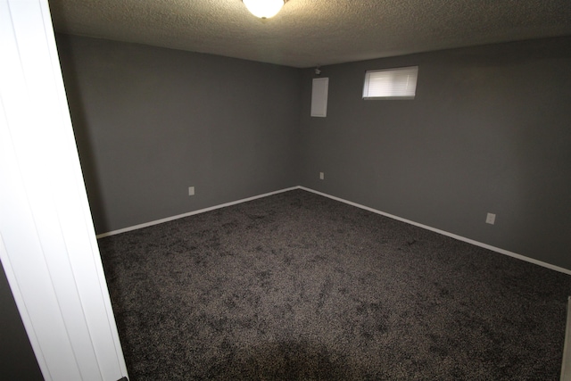 carpeted spare room featuring a textured ceiling