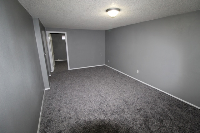 carpeted empty room with a textured ceiling