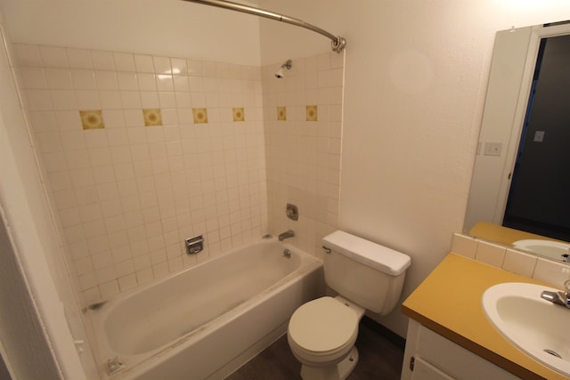 full bathroom with vanity, toilet, and tiled shower / bath combo