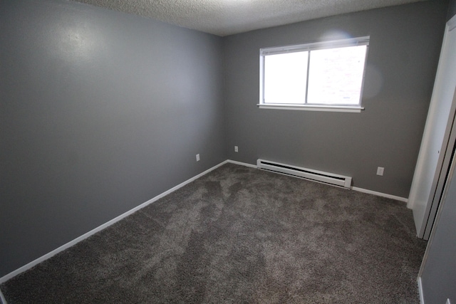 carpeted empty room featuring a textured ceiling and a baseboard radiator