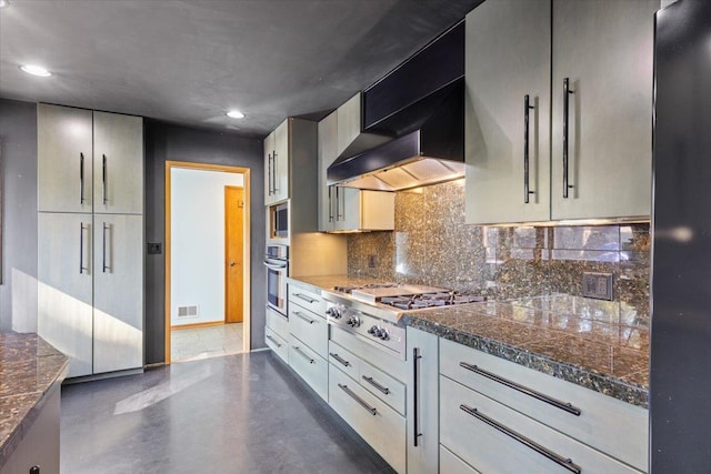 kitchen featuring gray cabinetry, tasteful backsplash, stainless steel appliances, and wall chimney exhaust hood