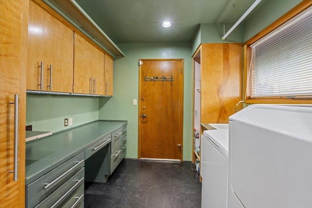 laundry room with cabinets and washer / dryer