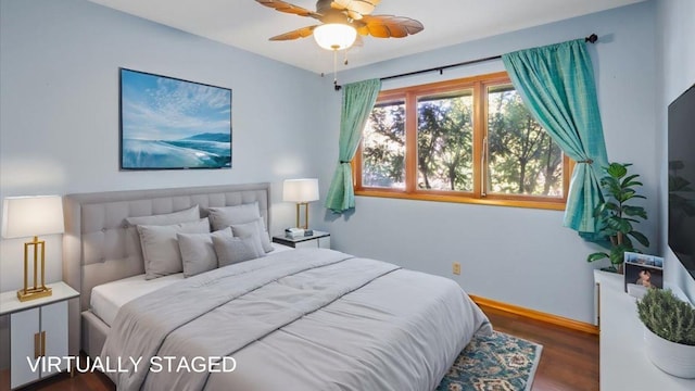 bedroom with dark hardwood / wood-style floors and ceiling fan