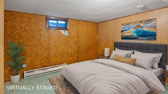 bedroom with wooden walls and baseboard heating