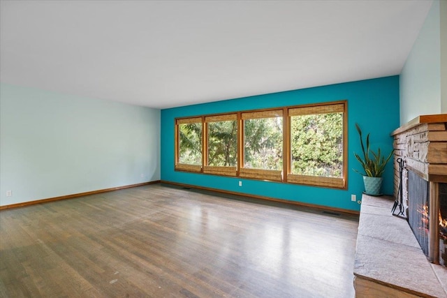 unfurnished living room with light hardwood / wood-style flooring and a fireplace