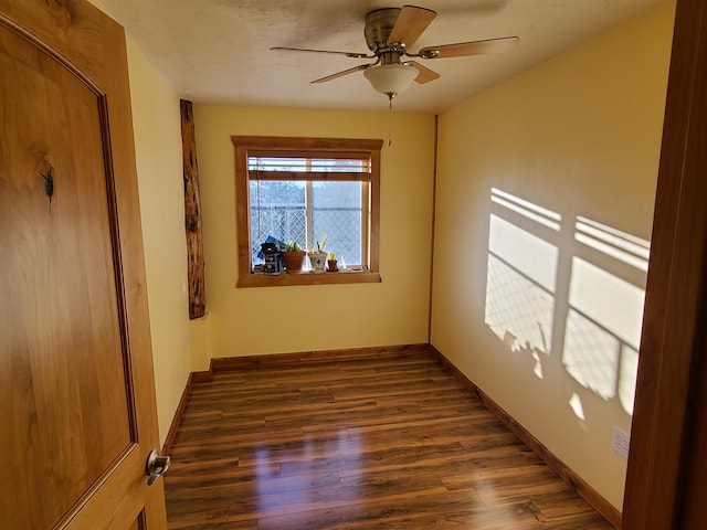 empty room featuring dark hardwood / wood-style floors and ceiling fan