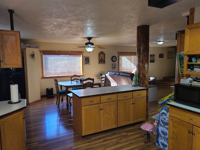 kitchen featuring a textured ceiling, ceiling fan, dark hardwood / wood-style floors, and plenty of natural light