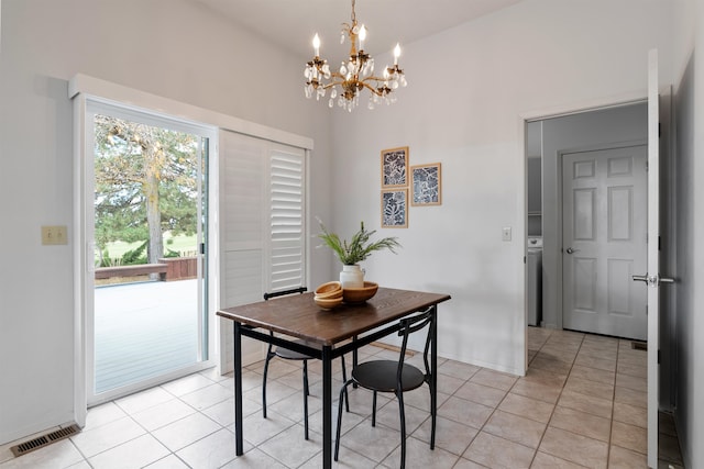 tiled dining space featuring lofted ceiling and a chandelier