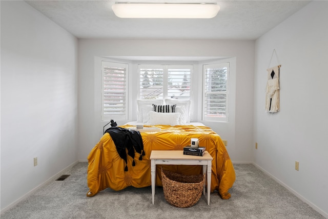 bedroom featuring light colored carpet