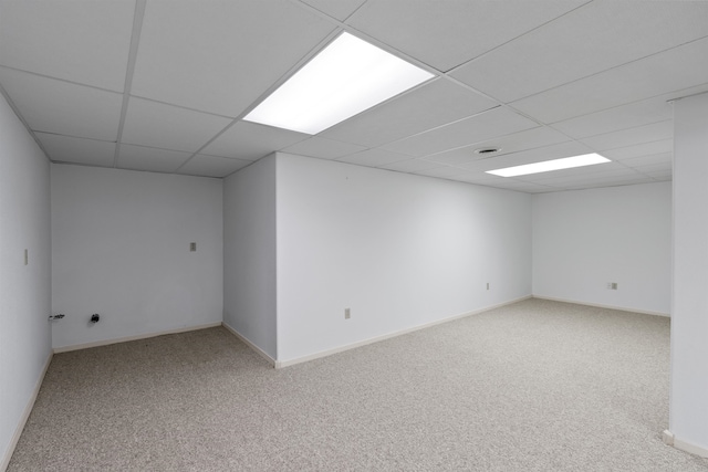 basement featuring carpet and a drop ceiling