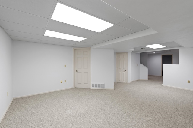 basement with a drop ceiling and carpet flooring